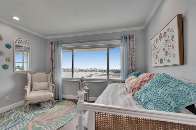bedroom featuring ornamental molding, baseboards, multiple windows, and wood finished floors