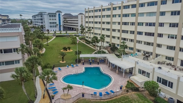 view of swimming pool with central AC and fence