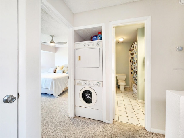 1500 Sunset Rd Unit C7, Tarpon Springs, FL 34689 - laundry room featuring stacked washer / dryer, carpet, baseboards, and ceiling fan
