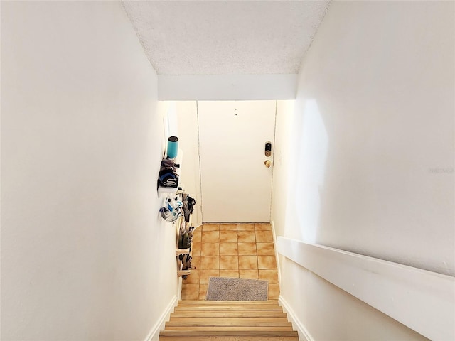1500 Sunset Rd Unit C7, Tarpon Springs, FL 34689 - staircase with a textured ceiling and tile patterned flooring