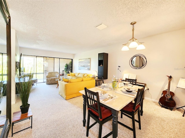 1500 Sunset Rd Unit C7, Tarpon Springs, FL 34689 - dining room featuring a textured ceiling and light carpet