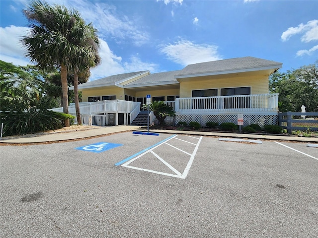 1500 Sunset Rd Unit C7, Tarpon Springs, FL 34689 - view of building exterior featuring stairs and uncovered parking