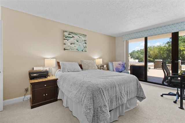 220 Belleview Blvd Unit 104, Belleair, FL 33756 - bedroom featuring access to exterior, light colored carpet, a desk, and a textured ceiling