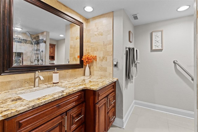220 Belleview Blvd Unit 104, Belleair, FL 33756 - bathroom featuring vanity, tiled shower, tile patterned floors, and recessed lighting