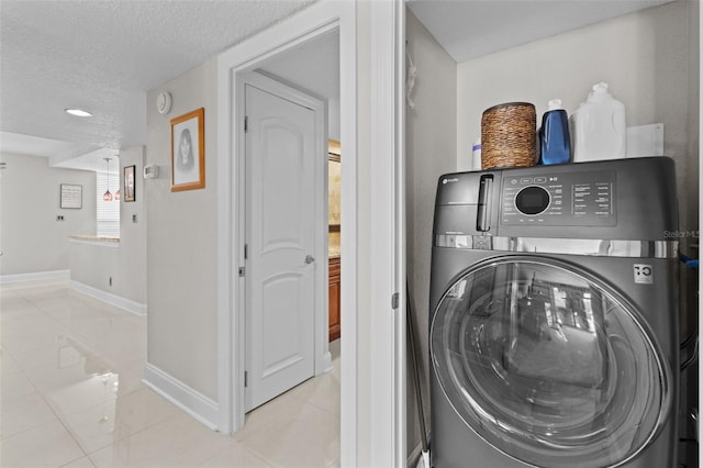220 Belleview Blvd Unit 104, Belleair, FL 33756 - laundry room featuring washer / clothes dryer, tile patterned floors, and a textured ceiling