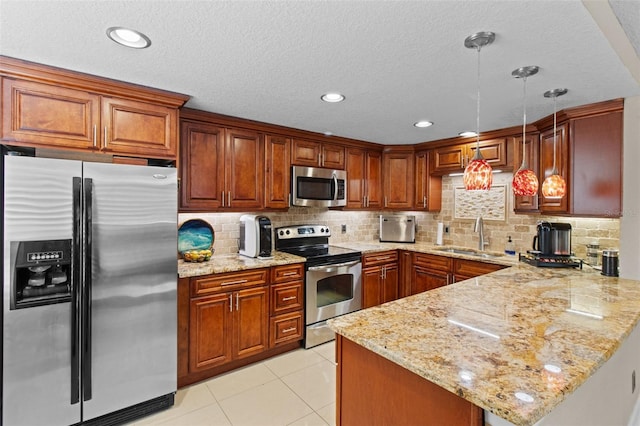 220 Belleview Blvd Unit 104, Belleair, FL 33756 - kitchen with appliances with stainless steel finishes, a peninsula, light stone counters, decorative backsplash, and recessed lighting