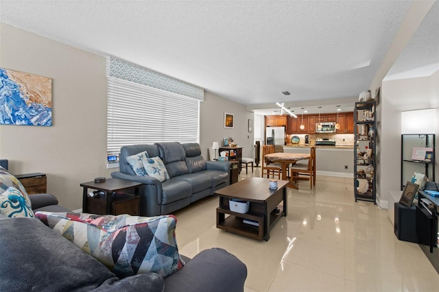 220 Belleview Blvd Unit 104, Belleair, FL 33756 - living area featuring a textured ceiling and light tile patterned floors