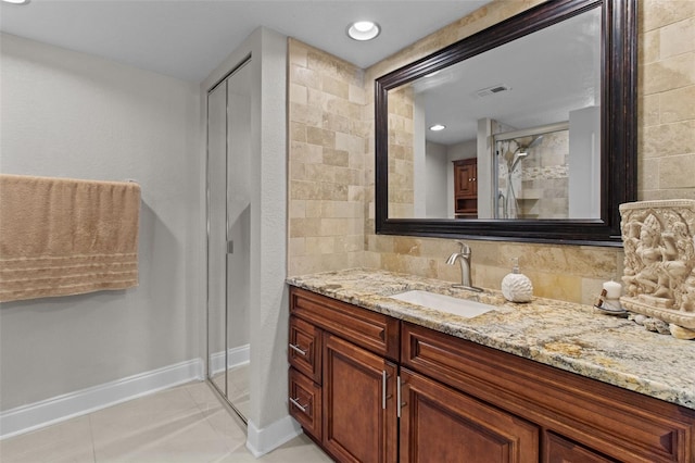 220 Belleview Blvd Unit 104, Belleair, FL 33756 - full bathroom featuring vanity, a shower stall, tile patterned floors, and backsplash