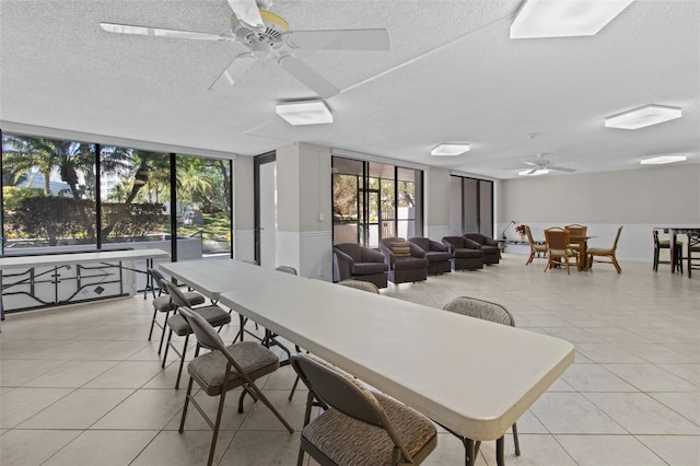 220 Belleview Blvd Unit 104, Belleair, FL 33756 - dining room with a ceiling fan, a textured ceiling, light tile patterned floors, and floor to ceiling windows