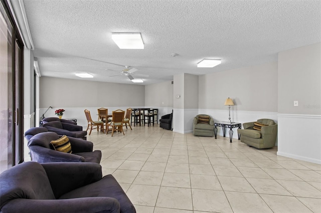 220 Belleview Blvd Unit 104, Belleair, FL 33756 - living area featuring light tile patterned floors, a textured ceiling, and a ceiling fan
