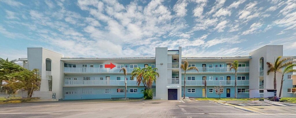 view of property featuring uncovered parking