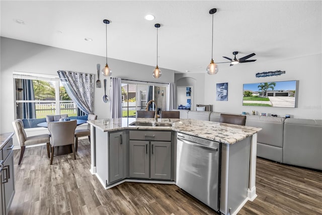 kitchen with stainless steel dishwasher, a ceiling fan, gray cabinets, a sink, and open floor plan