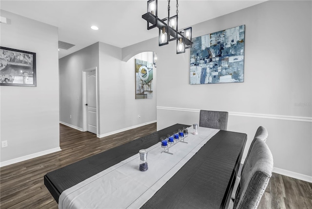 dining space featuring visible vents, baseboards, and wood finished floors