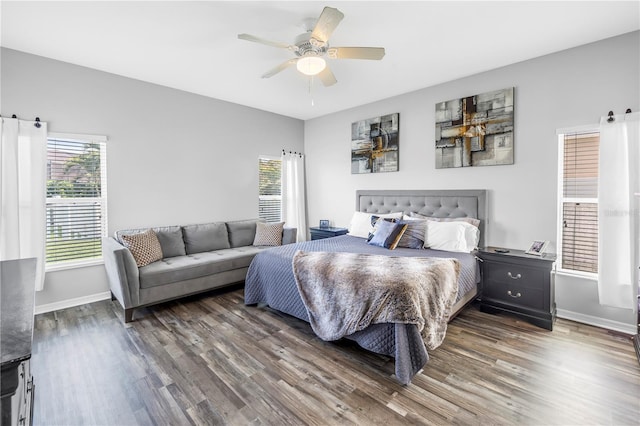 bedroom with ceiling fan, baseboards, and wood finished floors