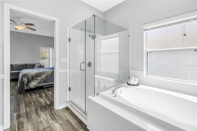 ensuite bathroom with a stall shower, ensuite bathroom, a bath, ceiling fan, and wood finished floors