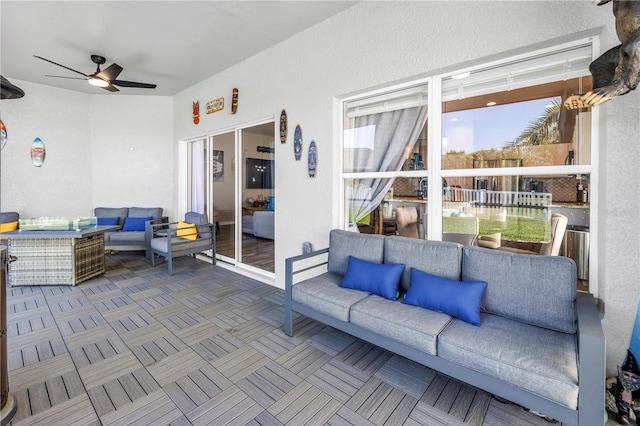sunroom / solarium with outdoor lounge area and a ceiling fan