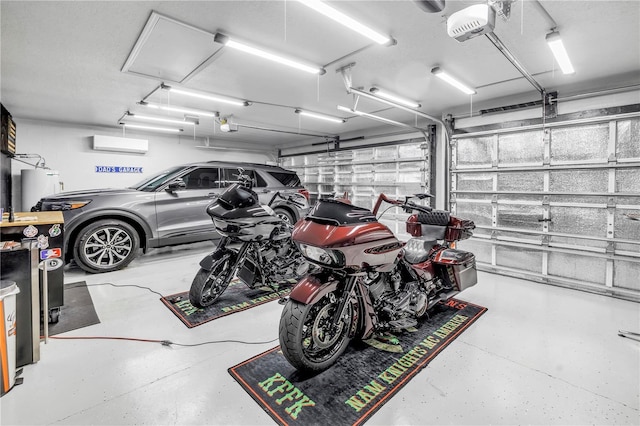 garage featuring water heater, a garage door opener, and a wall unit AC