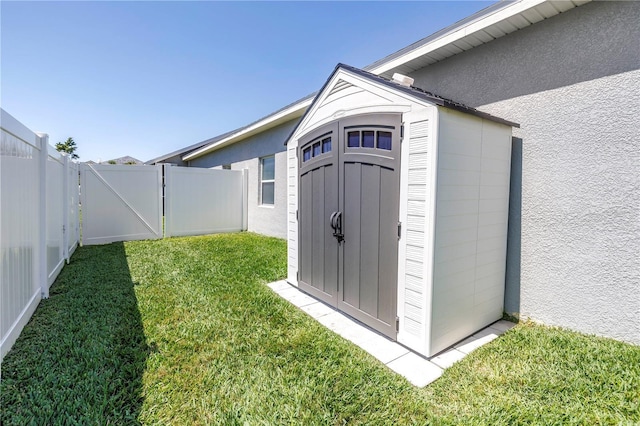 view of shed with a fenced backyard and a gate