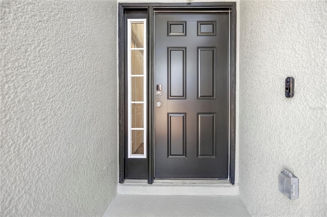 doorway to property with stucco siding