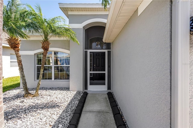 entrance to property with stucco siding
