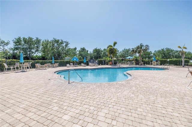 pool featuring a patio and fence