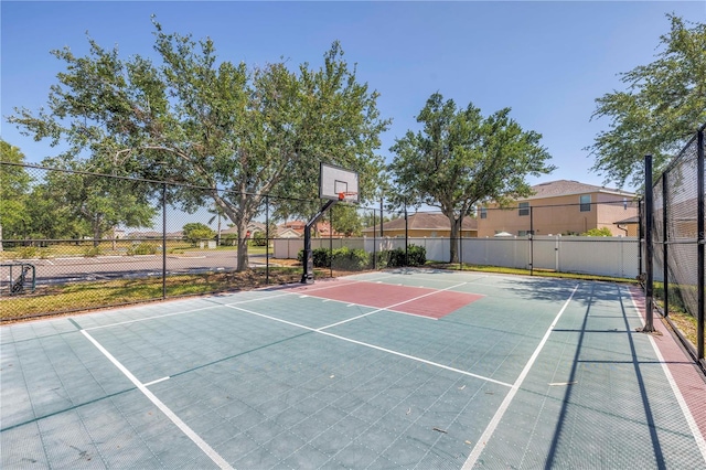 view of basketball court with fence and community basketball court