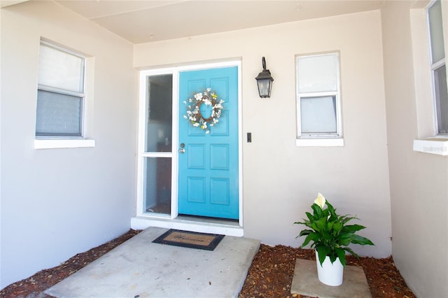 view of exterior entry with stucco siding