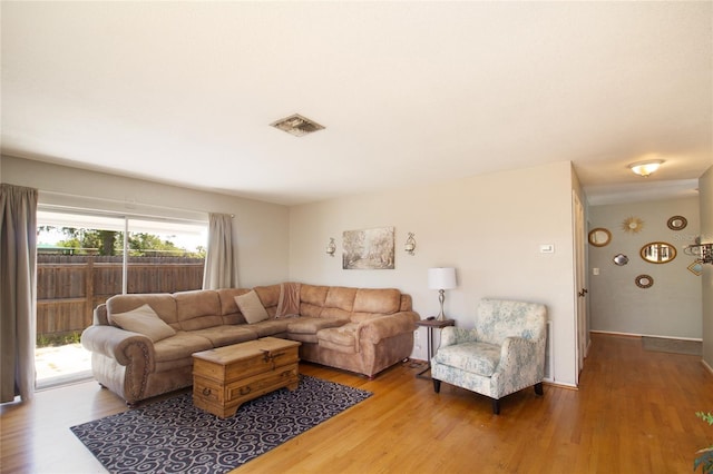living room with wood finished floors and visible vents