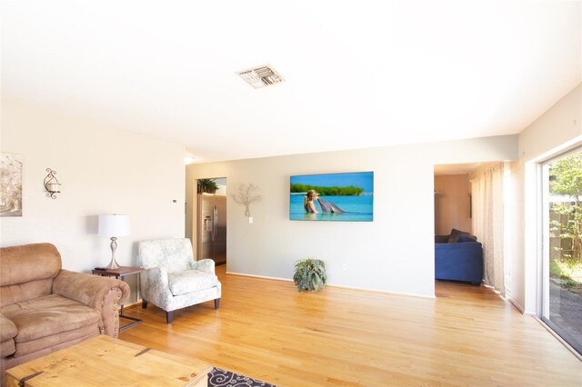 living room with light wood-type flooring and visible vents