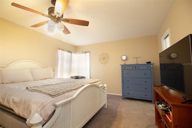bedroom with ceiling fan, baseboards, and light carpet