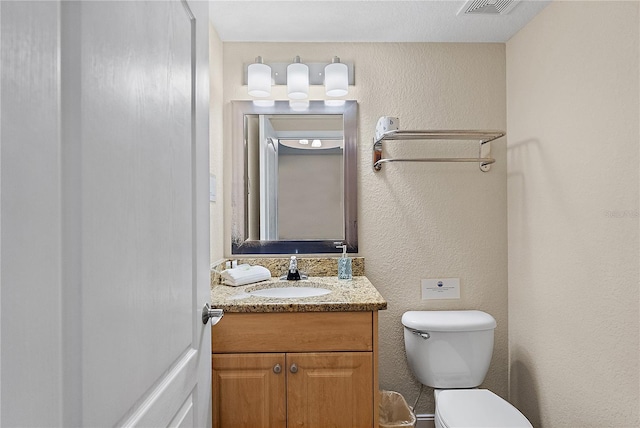 11605 Gulf Blvd Unit 203, Treasure Island, FL 33706 - half bath with toilet, vanity, and a textured wall