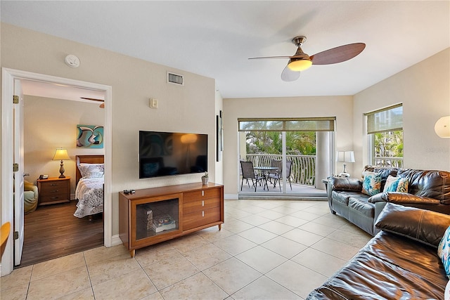 11605 Gulf Blvd Unit 203, Treasure Island, FL 33706 - living area with a ceiling fan, light tile patterned floors, and baseboards