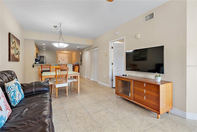 11605 Gulf Blvd Unit 203, Treasure Island, FL 33706 - living area with baseboards and light tile patterned flooring