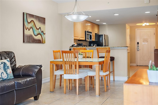 11605 Gulf Blvd Unit 203, Treasure Island, FL 33706 - dining space with baseboards, recessed lighting, and light tile patterned flooring