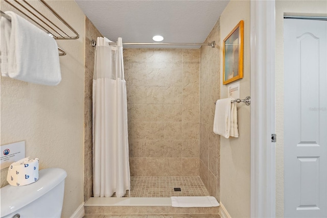 11605 Gulf Blvd Unit 203, Treasure Island, FL 33706 - bathroom featuring a tile shower and toilet