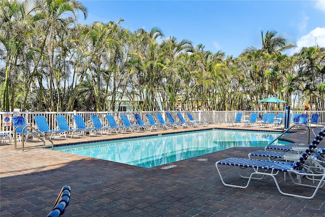 11605 Gulf Blvd Unit 203, Treasure Island, FL 33706 - community pool with a patio area and view of scattered trees