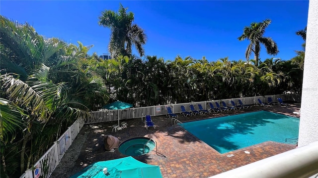 11605 Gulf Blvd Unit 203, Treasure Island, FL 33706 - community pool with a community hot tub and a patio area