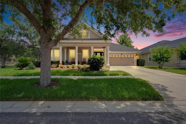 20537 Lace Cascade Rd, Land O Lakes, FL 34637 - view of front of house featuring an attached garage, driveway, a front lawn, covered porch, and stucco siding