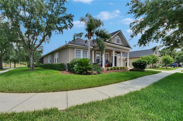 20537 Lace Cascade Rd, Land O Lakes, FL 34637 - view of front of home with stucco siding, a front lawn, and covered porch