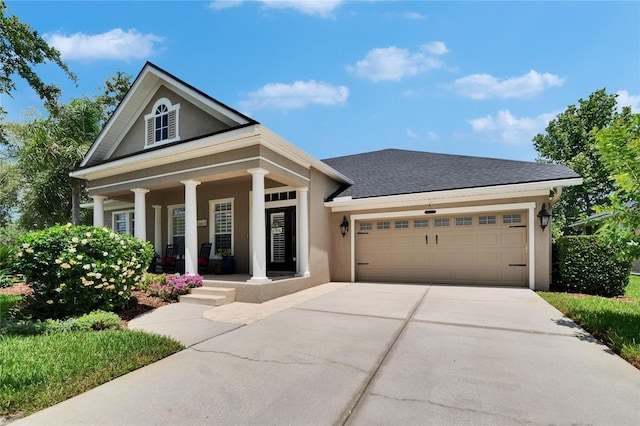 20537 Lace Cascade Rd, Land O Lakes, FL 34637 - greek revival house featuring a porch, driveway, an attached garage, and stucco siding