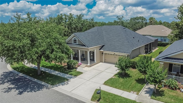 20537 Lace Cascade Rd, Land O Lakes, FL 34637 - view of front of house with a garage, covered porch, concrete driveway, stucco siding, and a front lawn