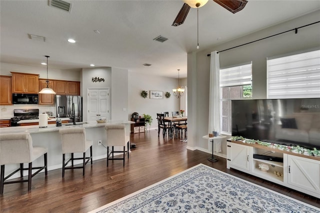 20537 Lace Cascade Rd, Land O Lakes, FL 34637 - living room with dark wood finished floors, recessed lighting, ceiling fan, a chandelier, and baseboards