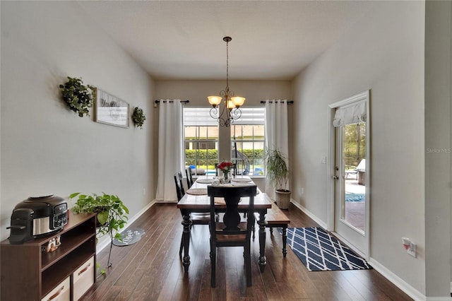 20537 Lace Cascade Rd, Land O Lakes, FL 34637 - dining room featuring a chandelier, dark wood-style floors, and baseboards