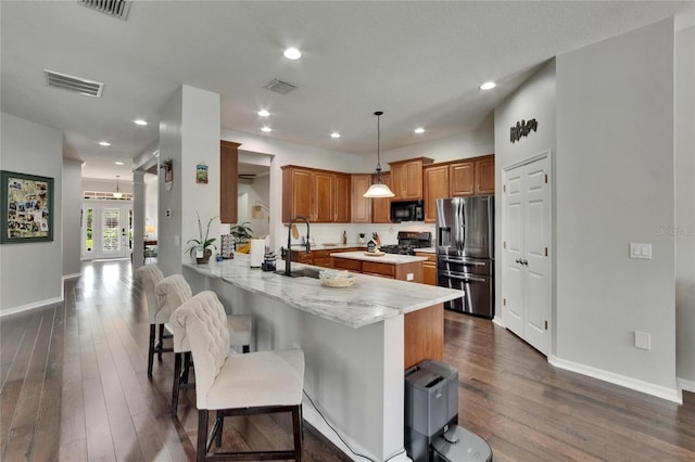 20537 Lace Cascade Rd, Land O Lakes, FL 34637 - kitchen featuring black appliances, dark wood finished floors, a sink, brown cabinets, and baseboards