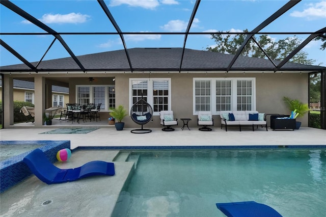 20537 Lace Cascade Rd, Land O Lakes, FL 34637 - rear view of house featuring an outdoor hangout area, stucco siding, a patio area, and an outdoor pool