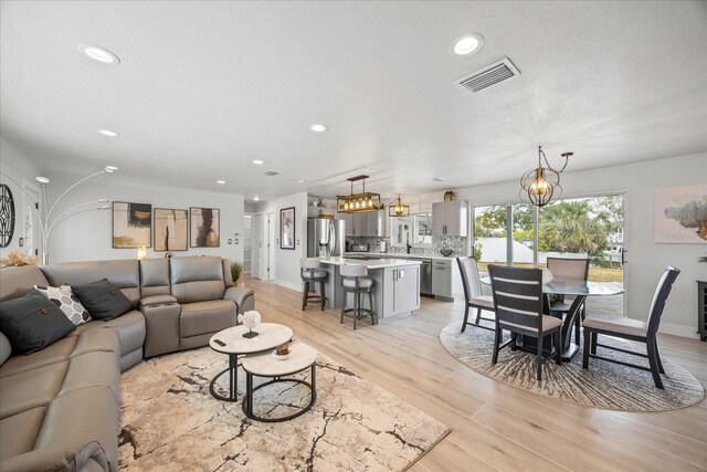 7889 3rd Ave S, Saint Petersburg, FL 33707 - living area with light wood-style flooring, recessed lighting, and baseboards