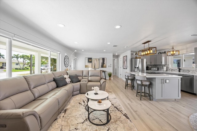 7889 3rd Ave S, Saint Petersburg, FL 33707 - living area featuring light wood finished floors and recessed lighting
