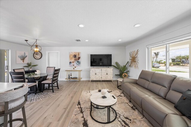 7889 3rd Ave S, Saint Petersburg, FL 33707 - living area featuring light wood-type flooring, recessed lighting, and baseboards