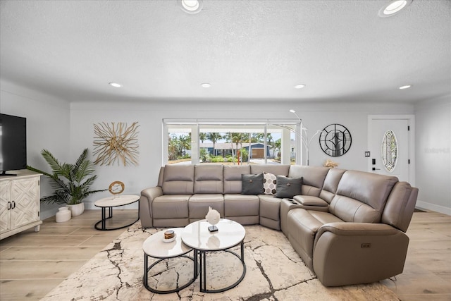 7889 3rd Ave S, Saint Petersburg, FL 33707 - living area with recessed lighting, light wood-style flooring, and a textured ceiling