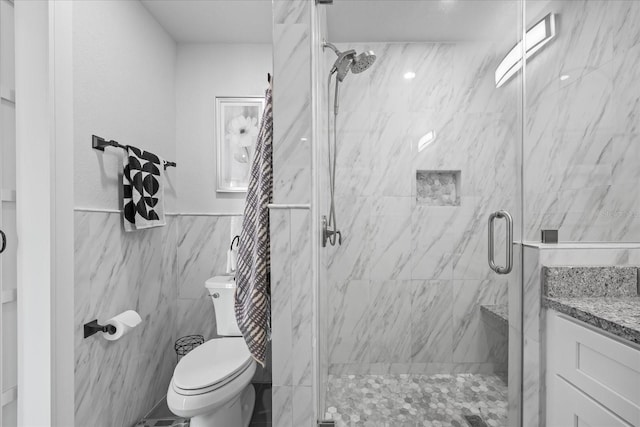 7889 3rd Ave S, Saint Petersburg, FL 33707 - full bathroom with a shower stall, tile walls, toilet, vanity, and a wainscoted wall
